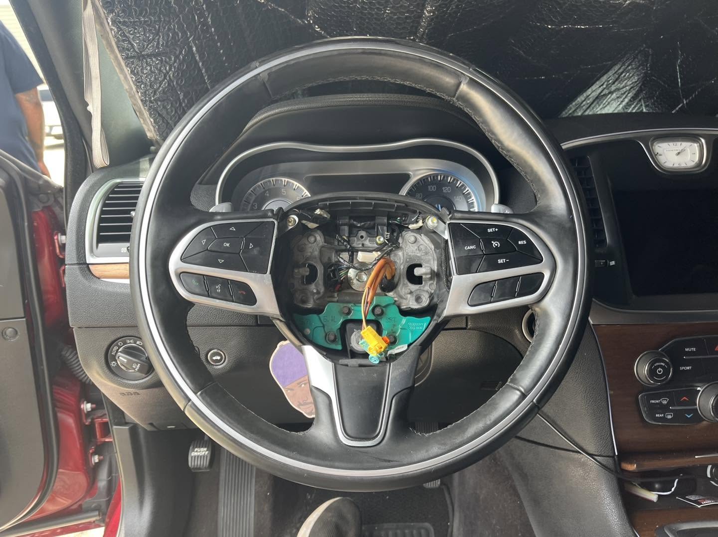 Vehicle steering wheel with trim removed for service